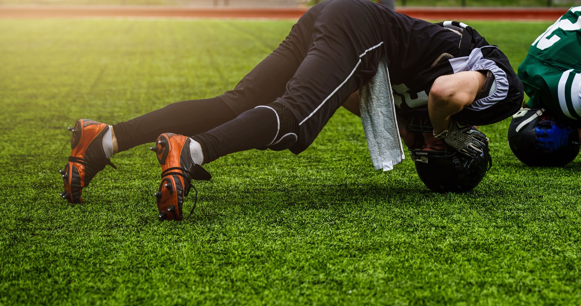 Football players stretching before a game