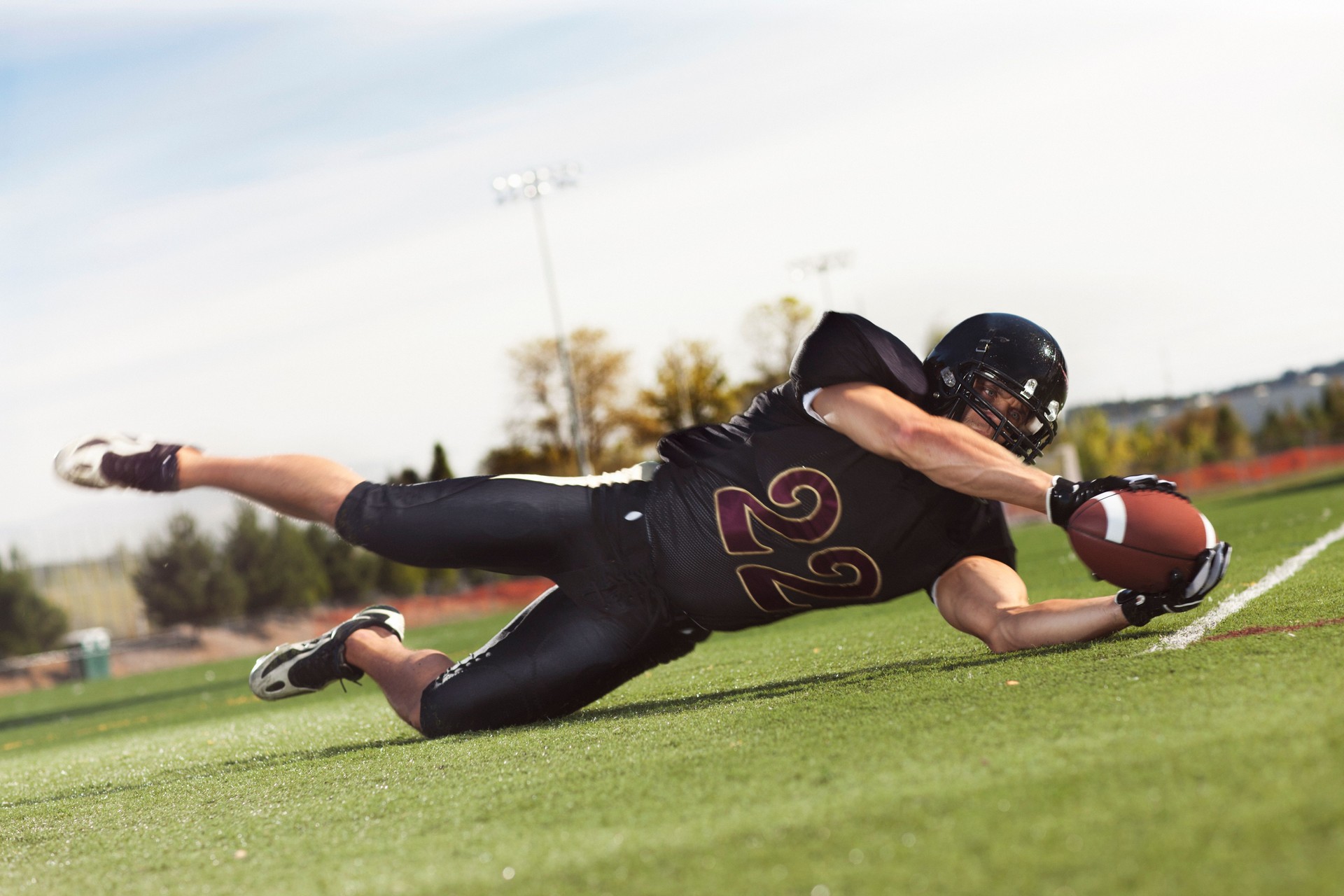 Football Player Diving to Catch the Ball